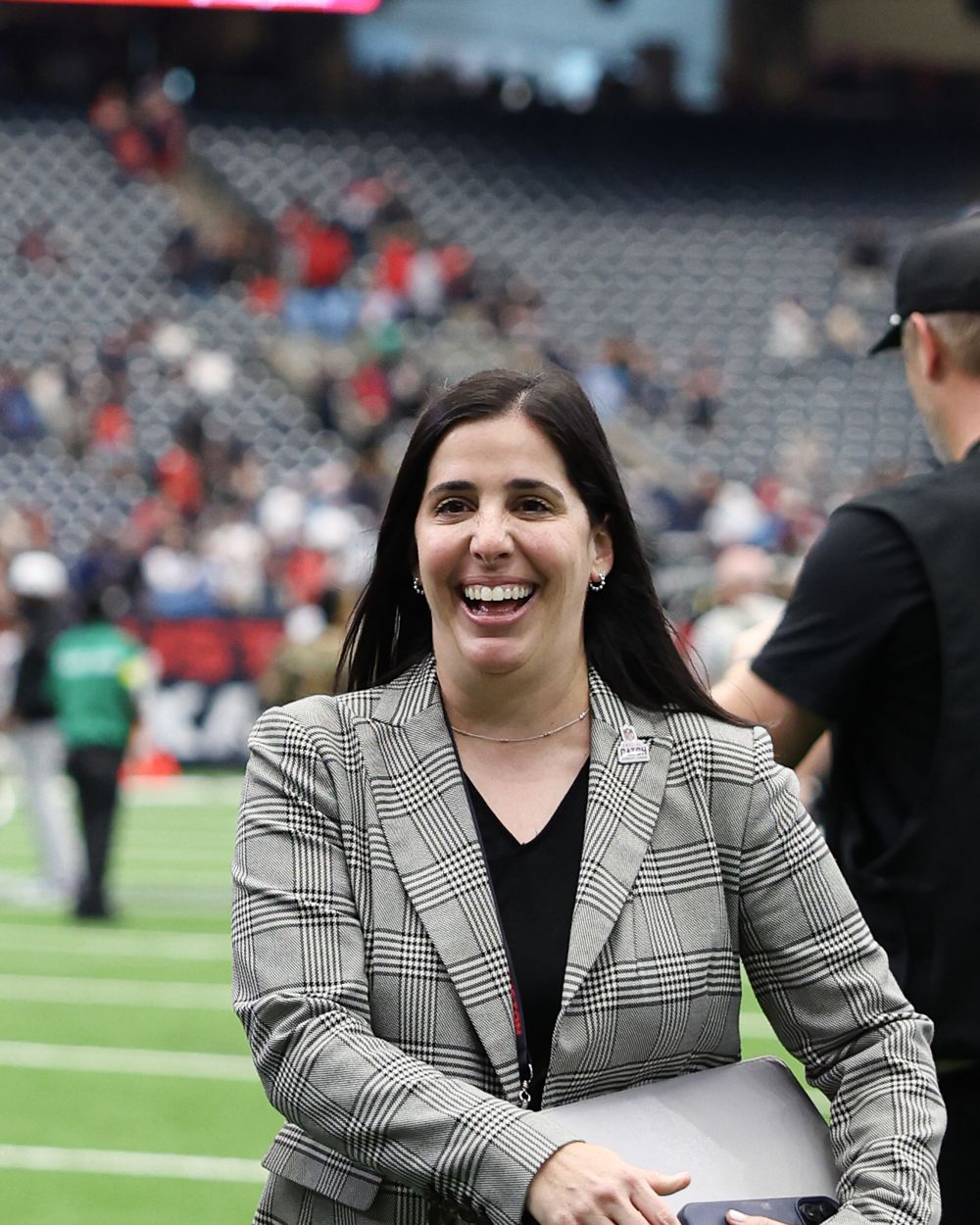 Lindsey Fox smiling on the field before a Houston Texans home game